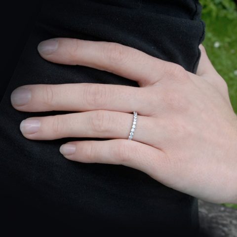 Titanium eternity ring worn on the finger.