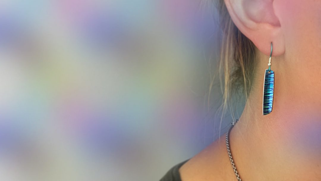 A close up of a woman's pink lips and her ring.
